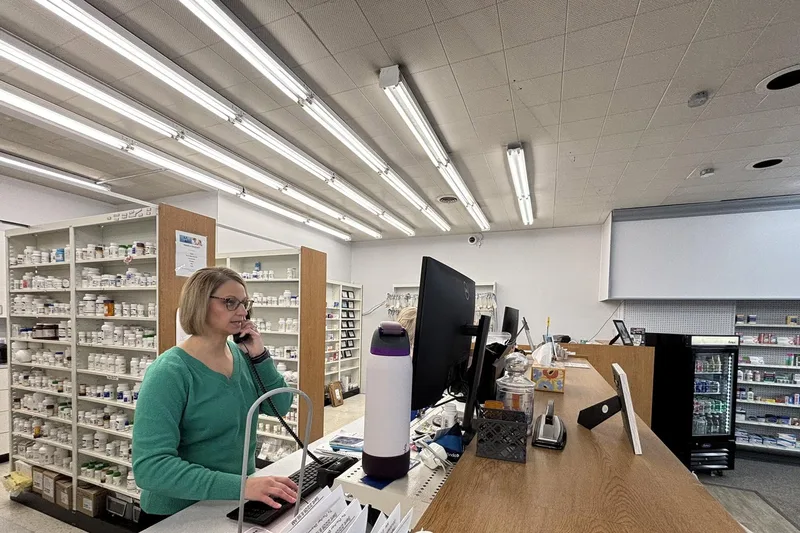 Dauber pharmacy staff member taking a call at the pharmacy counter