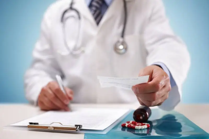 Pharmacist reviewing a medication list with a patient